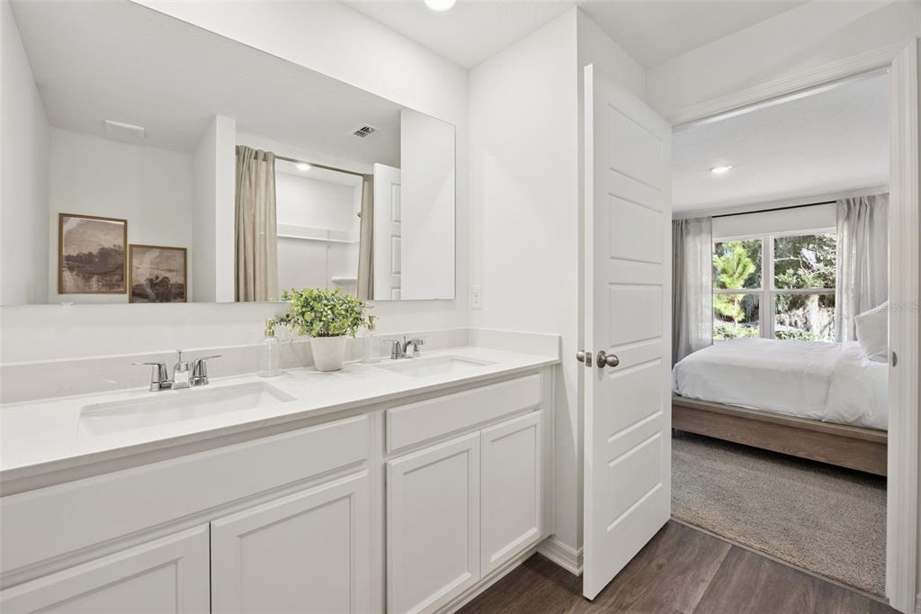 3417 Nettle Loop Tavares, FL 32778 - Photo 24 of 29 a en suite bathroom with a double vanity sink and mirror