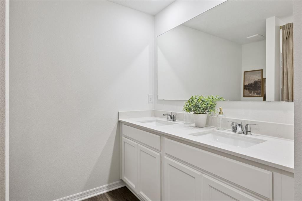 3417 Nettle Loop Tavares, FL 32778 - Photo 25 of 29 a bathroom with a sink and a mirror