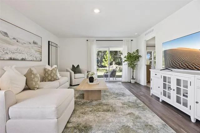 a living room with furniture and wooden floor