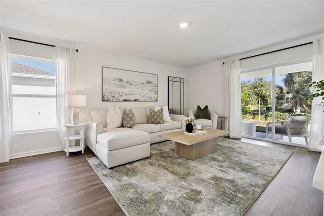 a living room with furniture and a large window