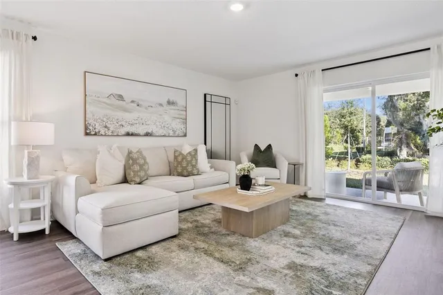 a living room with furniture and a large window