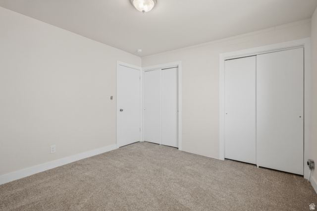 337 North Main Street Central Valley, UT 84754 - Photo 24 of 40 Unfurnished bedroom featuring multiple closets and light carpet