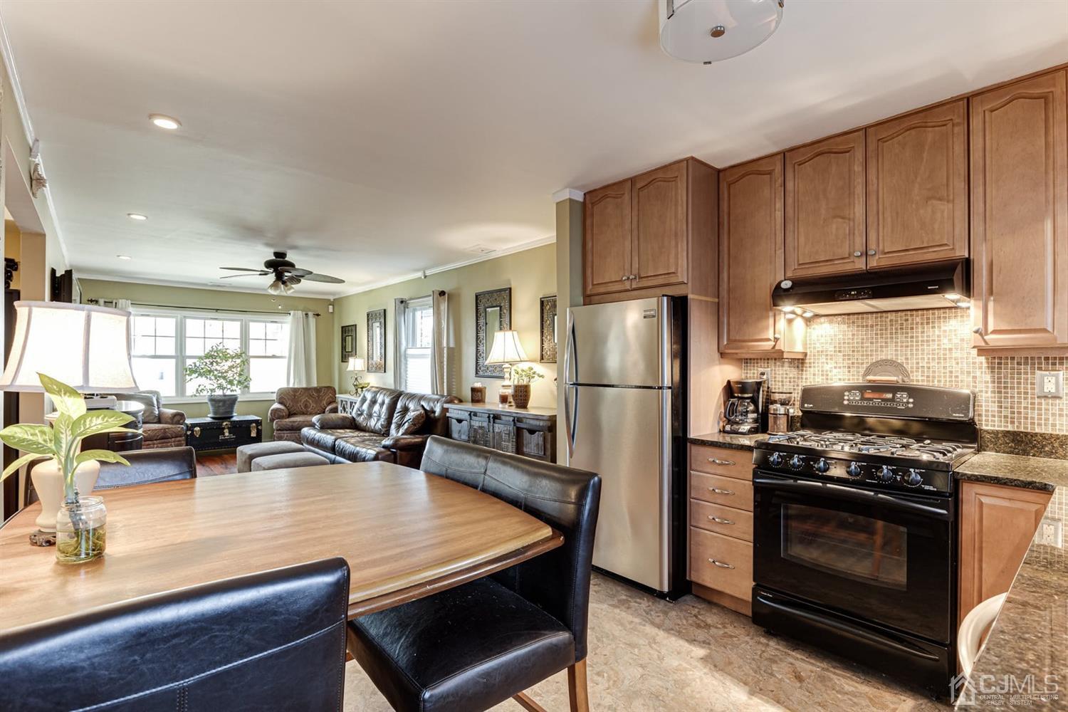 17 Melville Road Edison, NJ 08817 - Photo 14 of 26 a kitchen with stainless steel appliances a stove a sink a refrigerator cabinets and couches