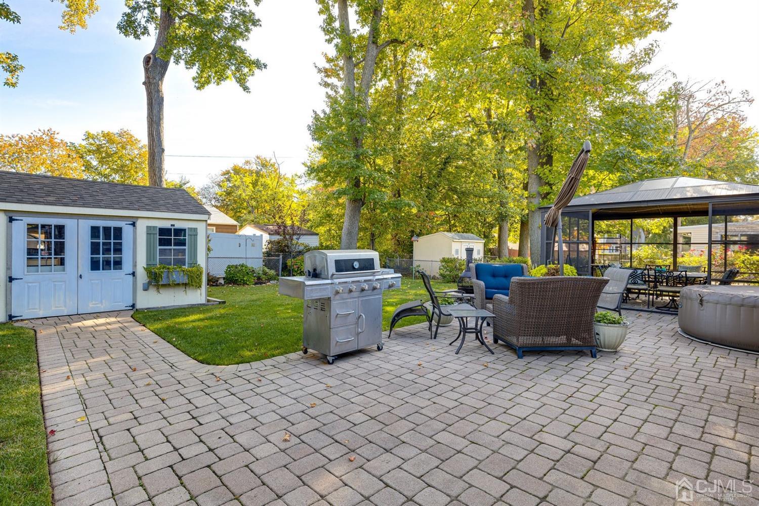 17 Melville Road Edison, NJ 08817 - Photo 22 of 26 a view of a patio with table and chairs potted plants and a large tree