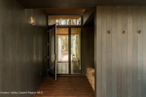 a view of hallway with wooden floor