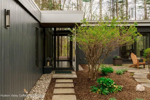 a front view of a house with a garden