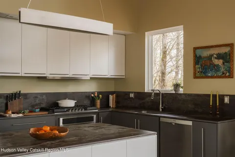 a kitchen with a sink a stove and cabinets