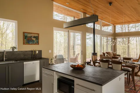 a view of a kitchen with granite countertop a sink and a counter top space