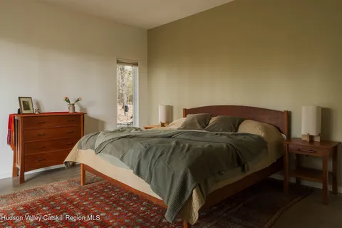 a bedroom with a bed and dresser