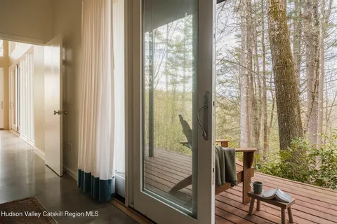 a view of a balcony with wooden floor and outside view