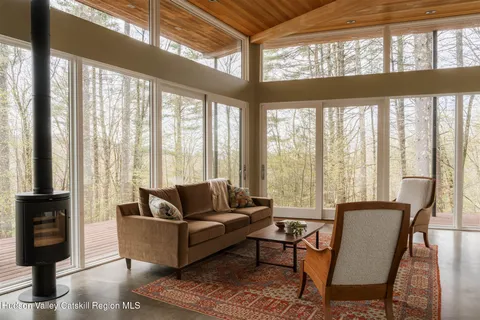 a living room with furniture and floor to ceiling windows