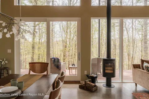 a view of a livingroom with furniture and floor to ceiling windows