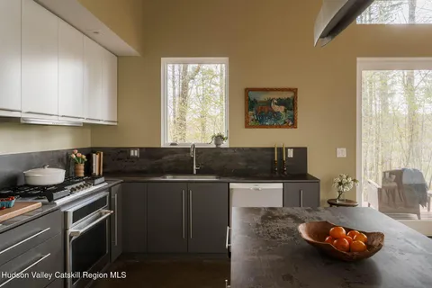 a kitchen with a sink and a stove top oven
