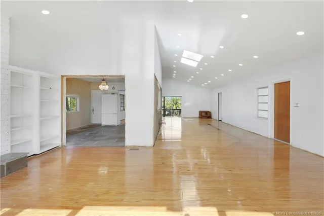 a view of a hallway with wooden floor