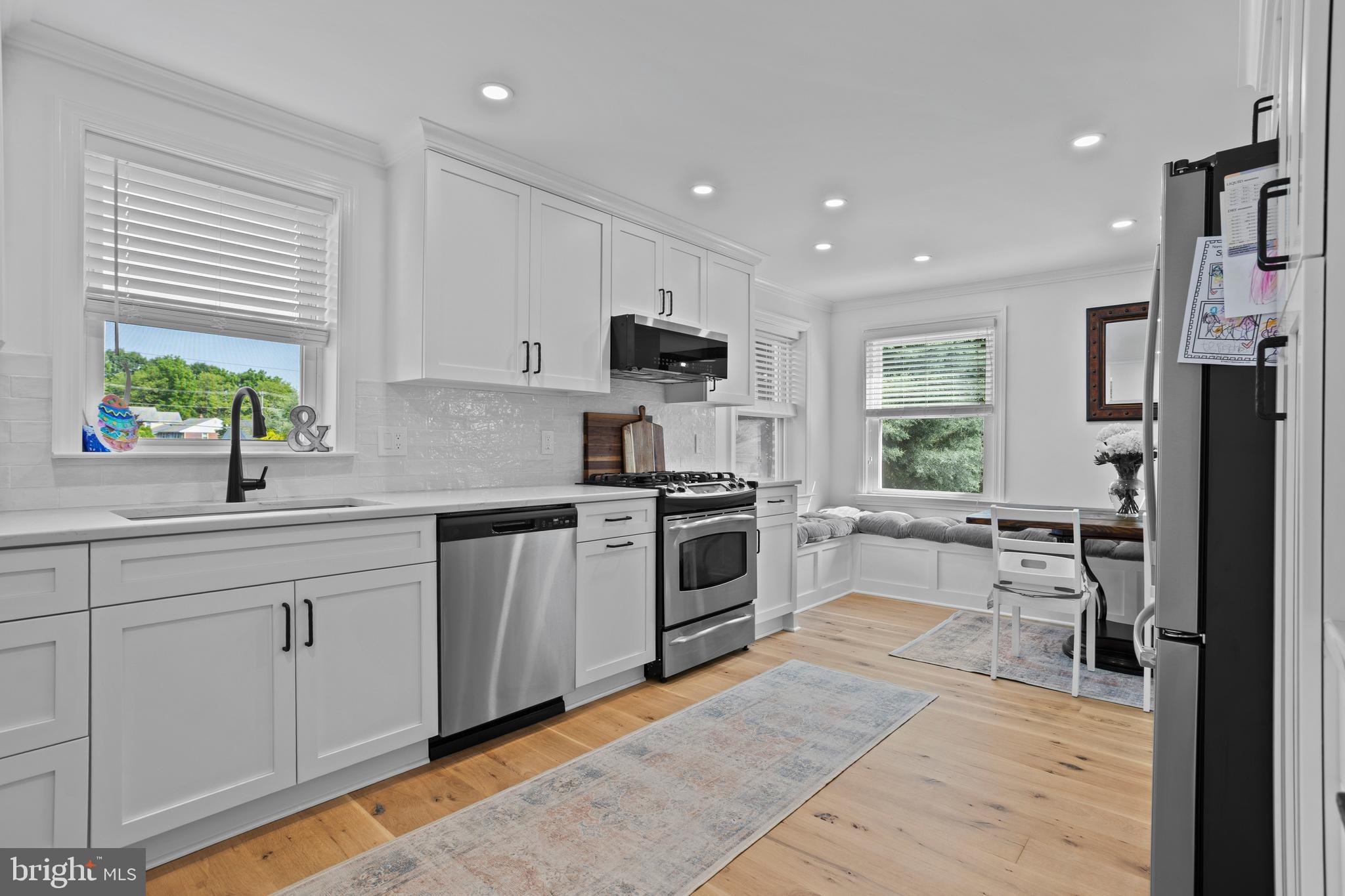 46 Plymouth Road Springfield, PA 19064 - Photo 6 of 30 a kitchen with stainless steel appliances granite countertop a stove top oven a sink dishwasher and a refrigerator