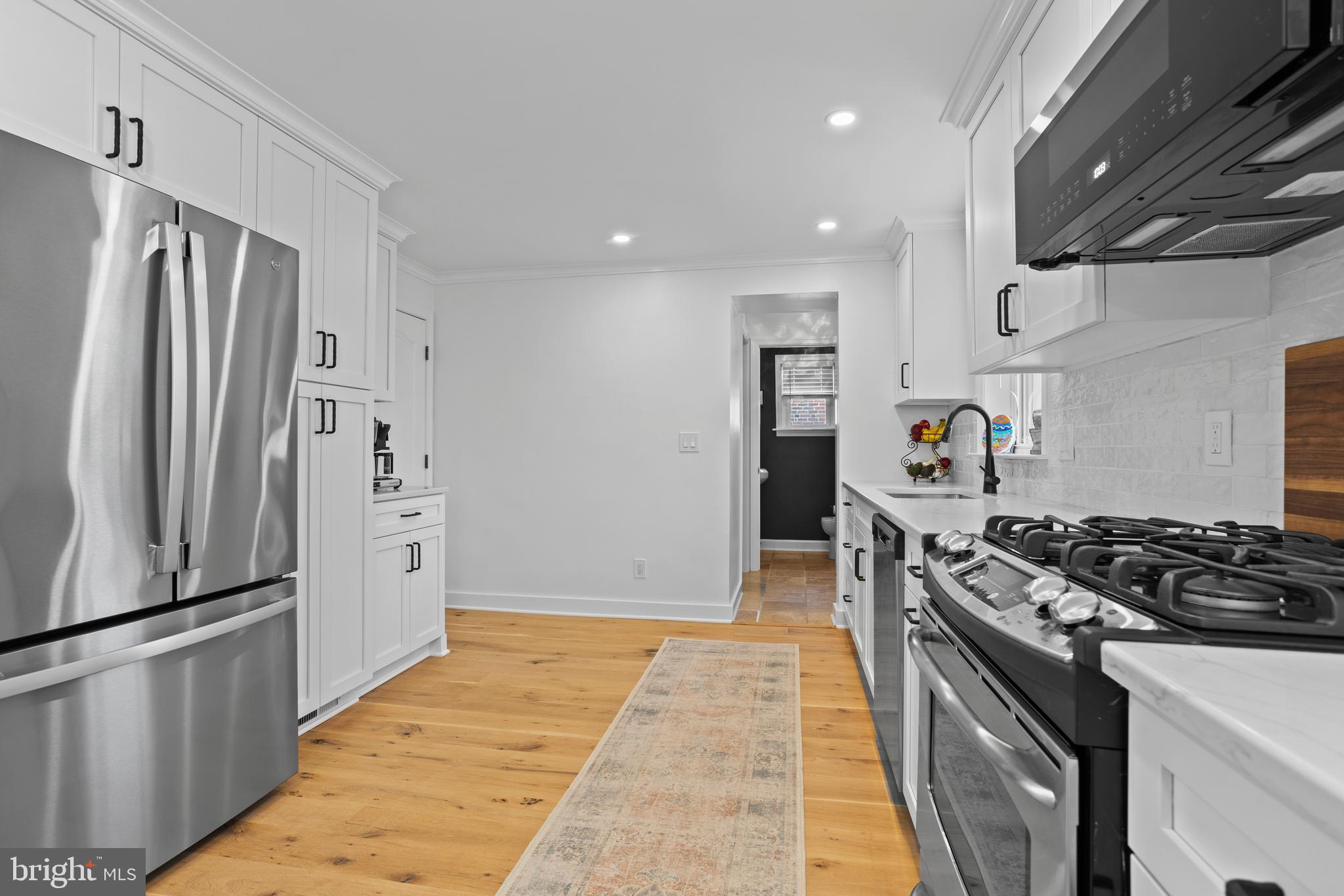 46 Plymouth Road Springfield, PA 19064 - Photo 7 of 30 a kitchen with stainless steel appliances granite countertop a refrigerator and a stove
