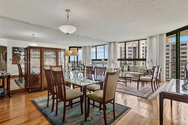 a kitchen with stainless steel appliances granite countertop a refrigerator a stove and a sink with cabinets