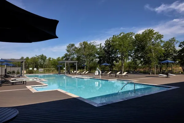 a room with wooden floor and windows