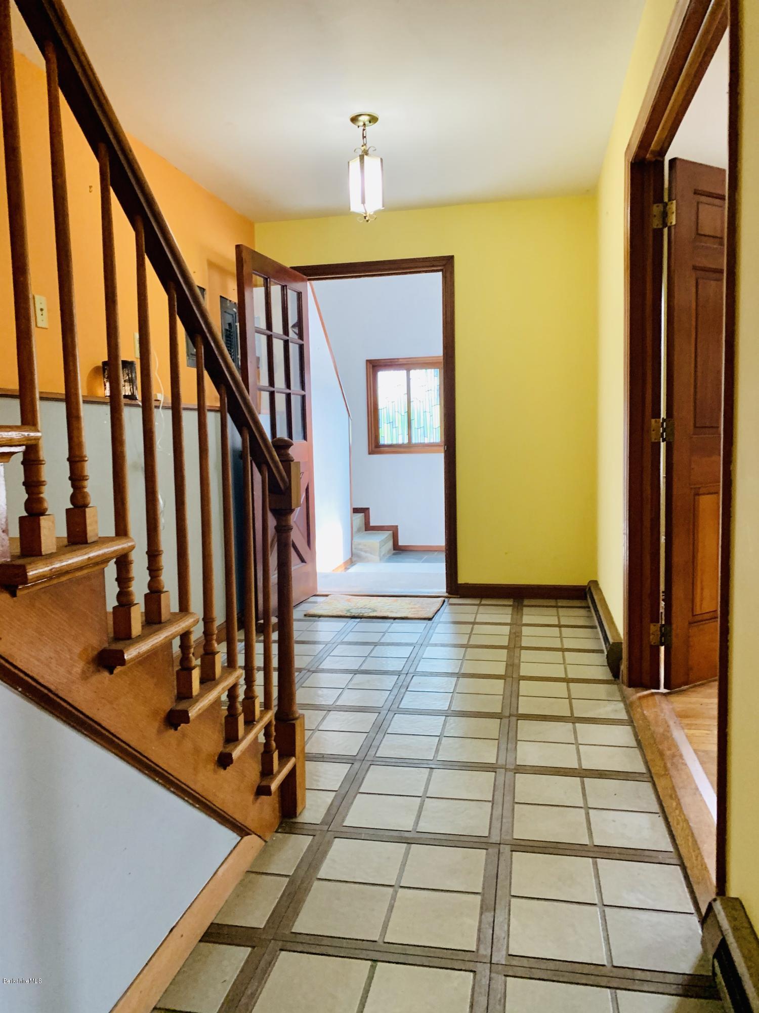 3582 Jacobs Ladder Road Becket, MA 01223 - Photo 8 of 32 a view of a hallway with wooden floor and staircase