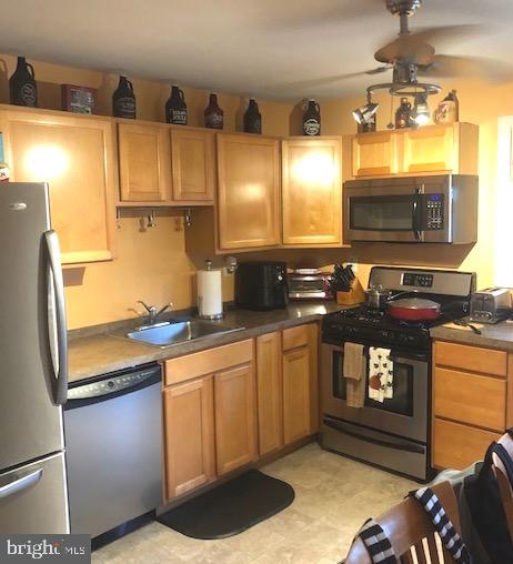 137 Estates Road Pine Hill, NJ 08021 - Photo 5 of 5 a kitchen with stainless steel appliances a stove a sink and a microwave