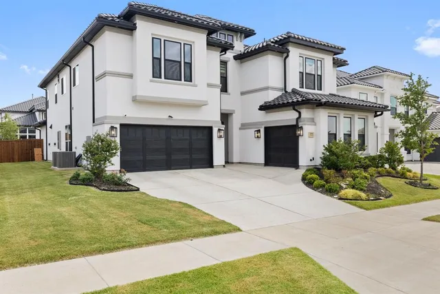 a front view of a house with a garden and plants