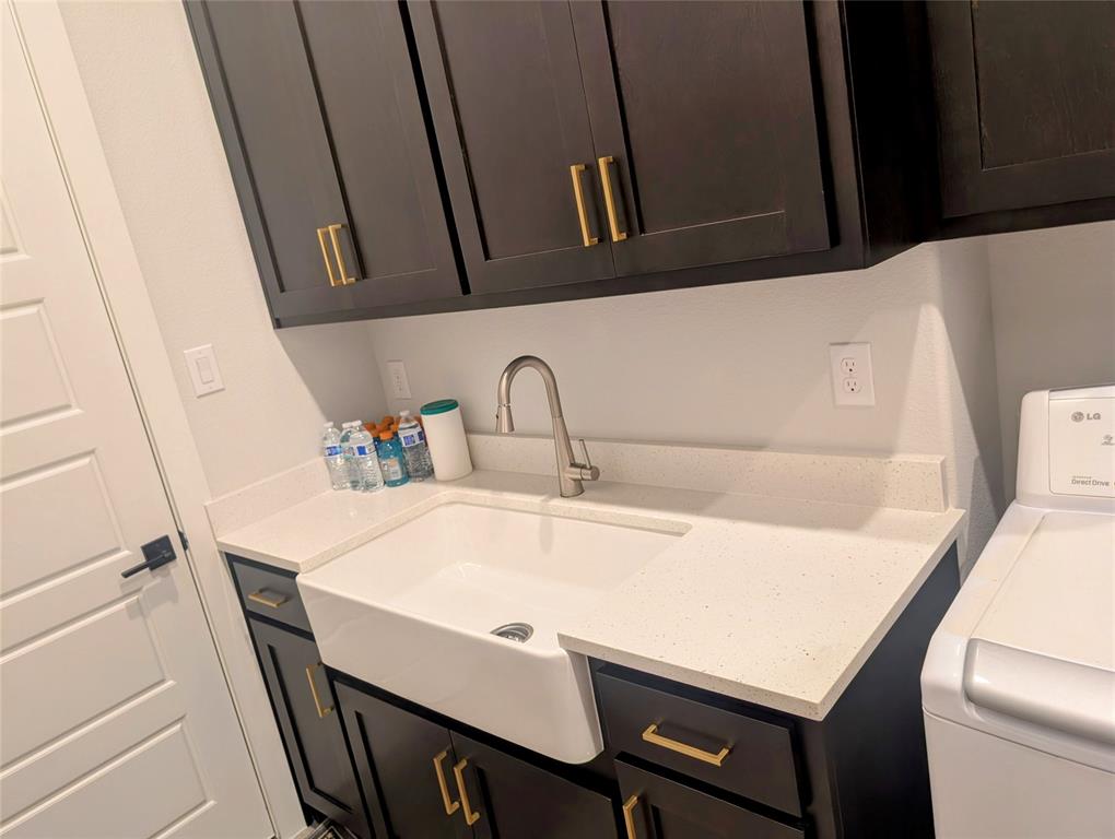 11991 Cloverdale Road Frisco, TX 75035 - Photo 15 of 40 a bathroom with a sink and a washer dryer