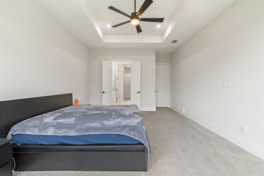 11991 Cloverdale Road Frisco, TX 75035 - Photo 20 of 40 a bedroom with a bed and ceiling fan