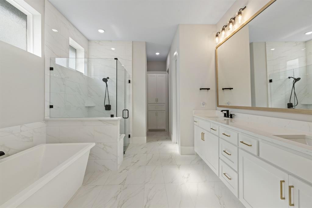 11991 Cloverdale Road Frisco, TX 75035 - Photo 21 of 40 a bathroom with a tub sink shower and mirror