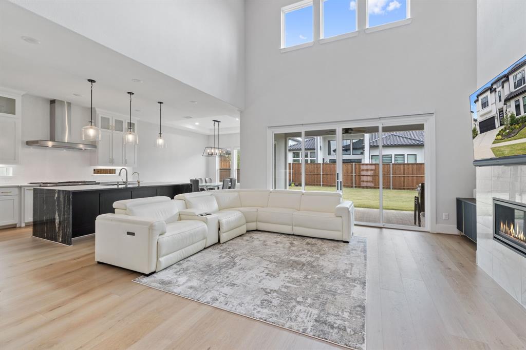 11991 Cloverdale Road Frisco, TX 75035 - Photo 3 of 40 a living room with furniture and a fireplace