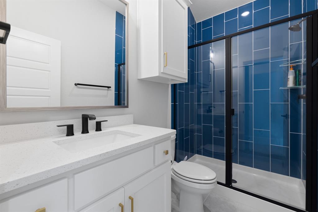 11991 Cloverdale Road Frisco, TX 75035 - Photo 31 of 40 a bathroom with a sink a toilet and shower