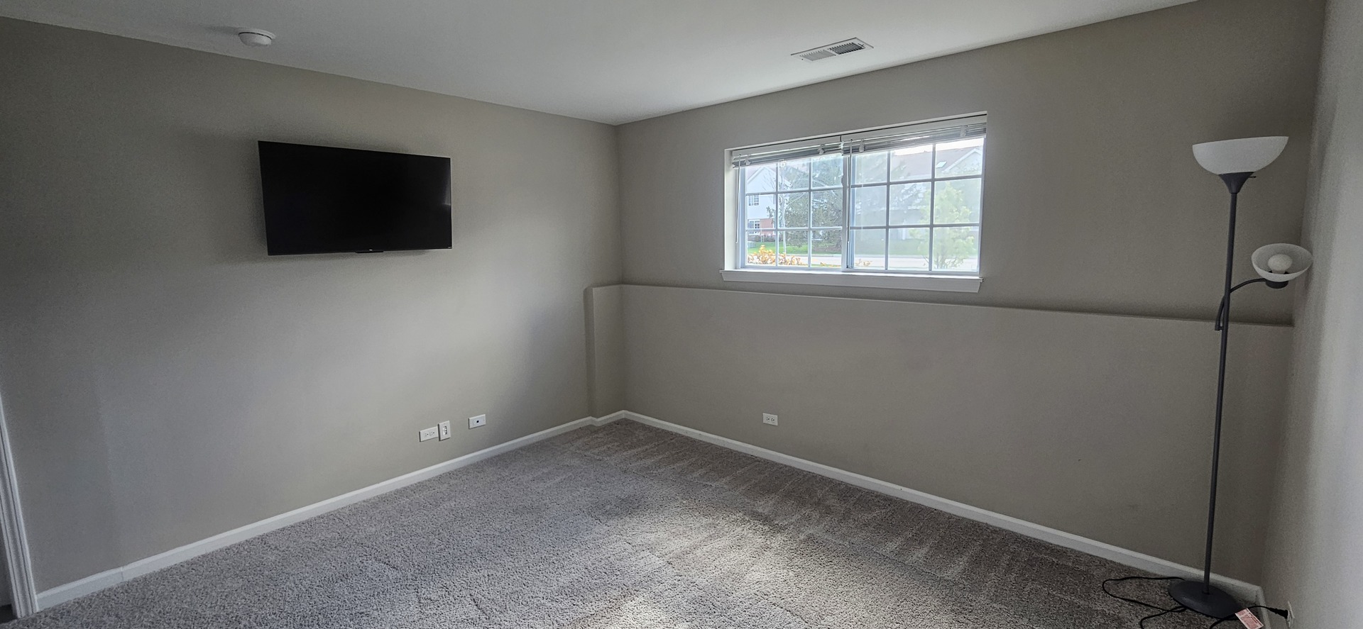 210 Timberleaf Circle Roselle, IL 60172 - Photo 12 of 14 an empty room with a flat screen tv and a window