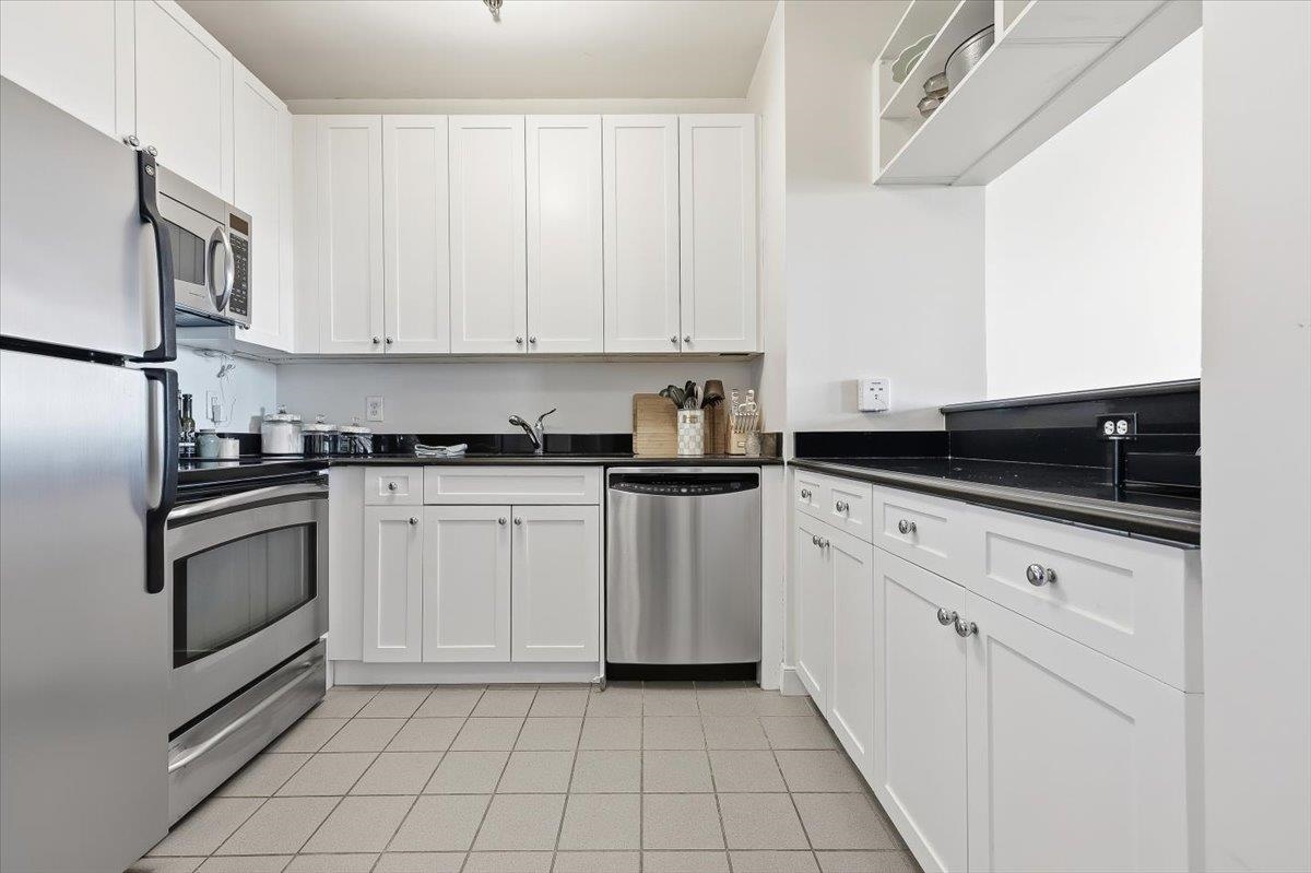 1500 Washington Street, Unit 8K Hoboken, NJ 07030 - Photo 12 of 43 a kitchen with white cabinets and appliances