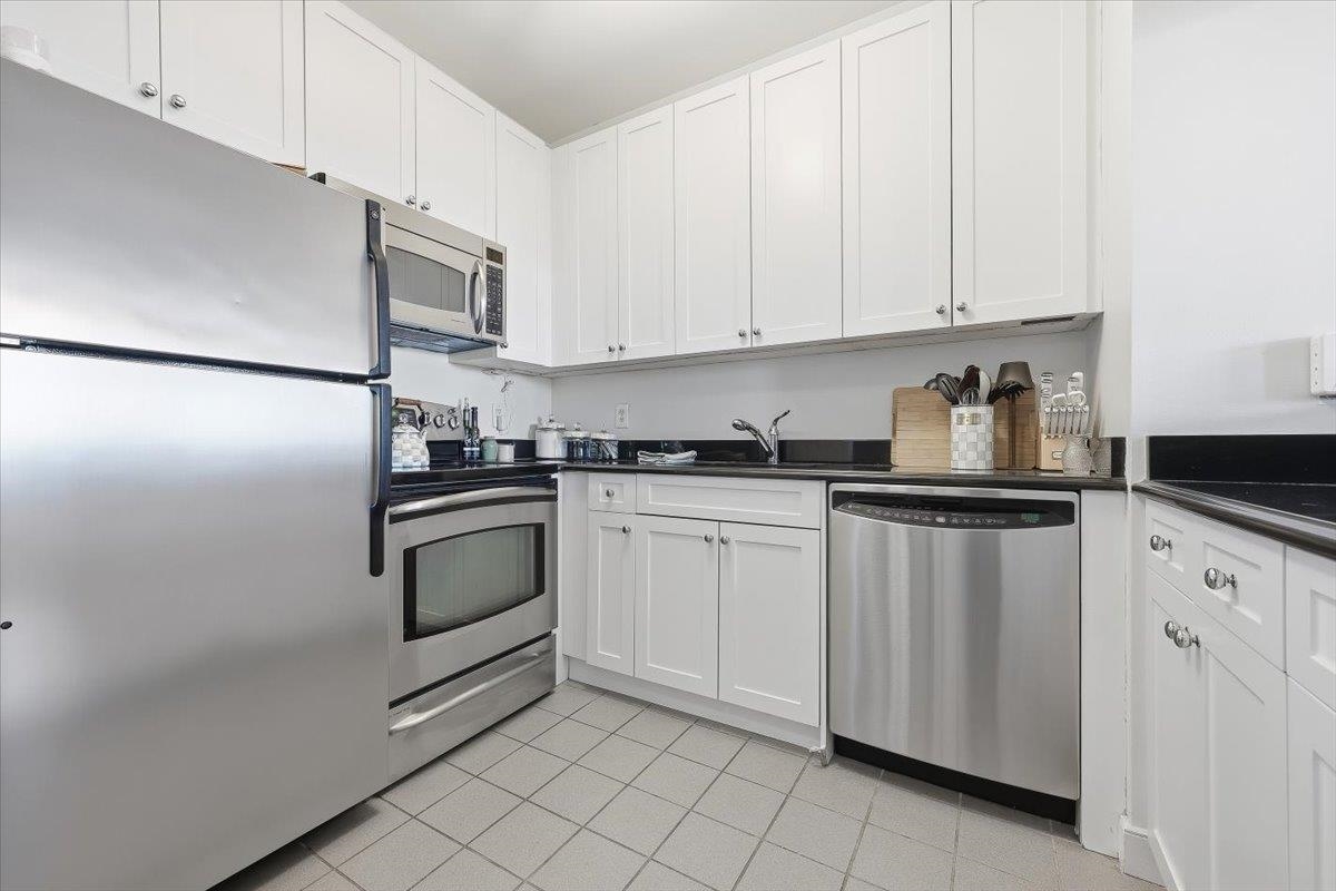 1500 Washington Street, Unit 8K Hoboken, NJ 07030 - Photo 13 of 43 a kitchen with white cabinets and white appliances