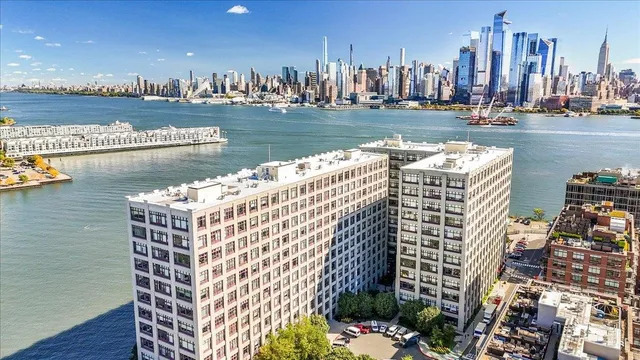a view of swimming pool with outdoor seating and city view