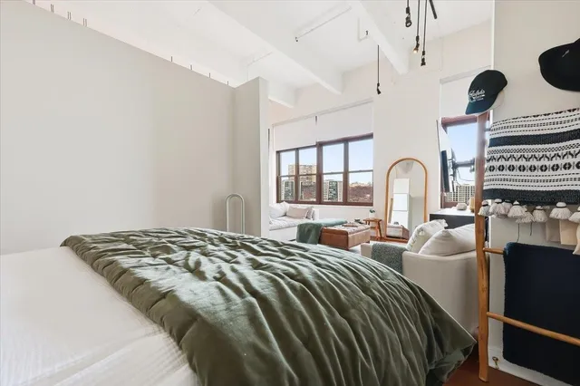 a bedroom with bed and a window