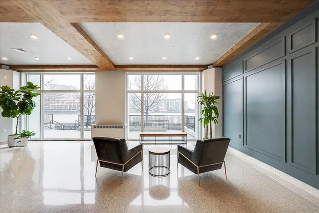 a lobby with furniture and large windows