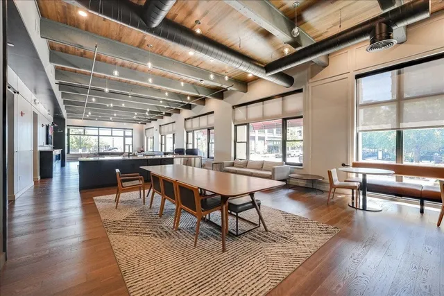 a reading room with furniture wooden floor and a window