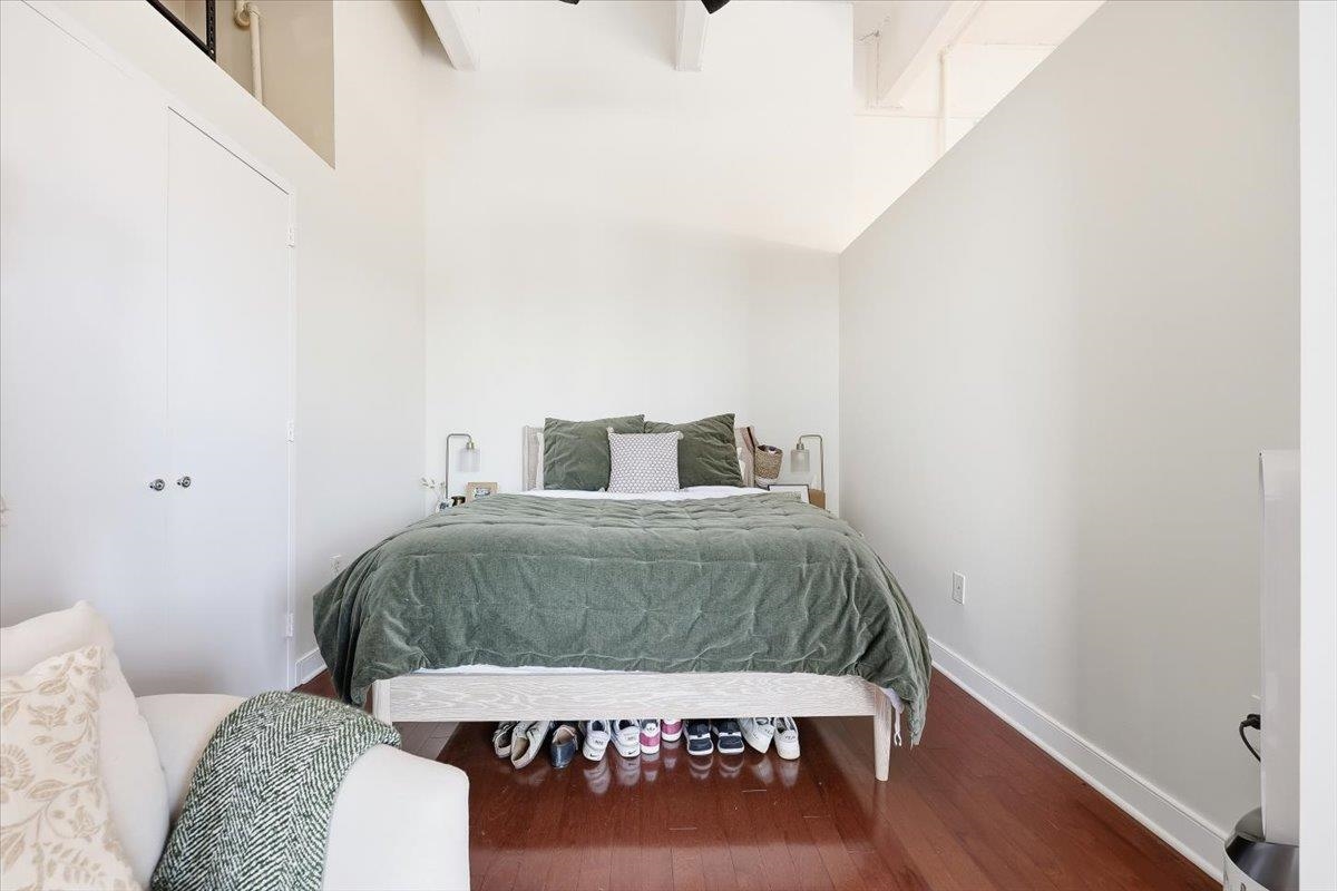 1500 Washington Street, Unit 8K Hoboken, NJ 07030 - Photo 5 of 43 a bedroom with a bed and a table with wooden floor