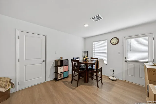 a kitchen with refrigerator cabinets and wooden floor