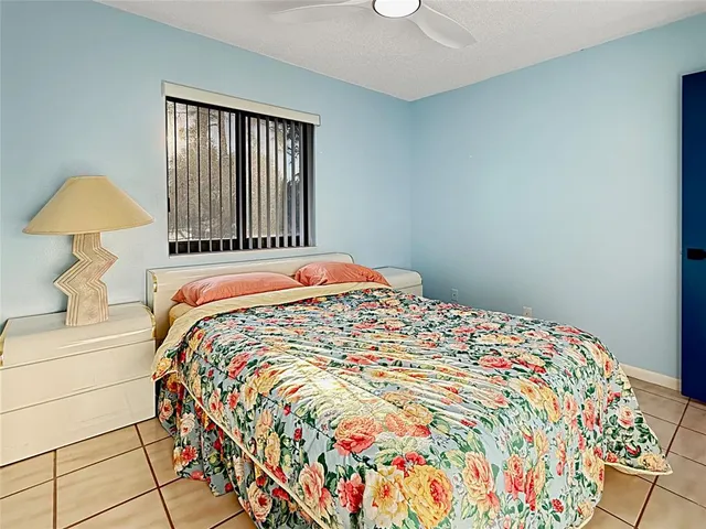 a bedroom with a bed and a lamp