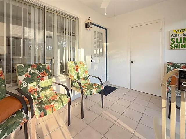 a spacious bedroom with a bed and a chandelier