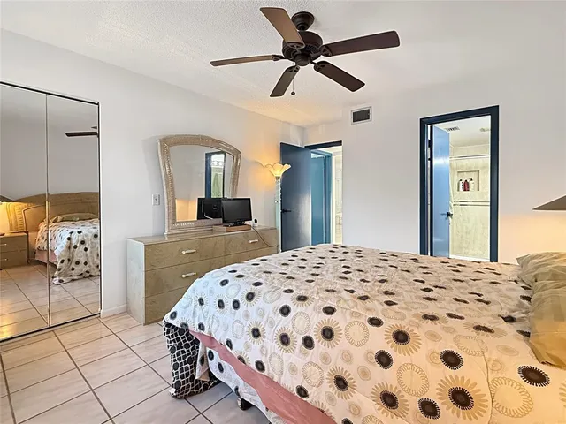 a bedroom with a bed and a mirror on dresser