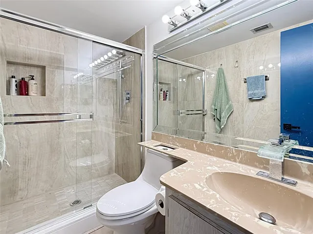 a bathroom with a sink toilet and shower