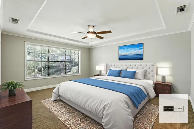 a spacious bedroom with a large bed and a chandelier