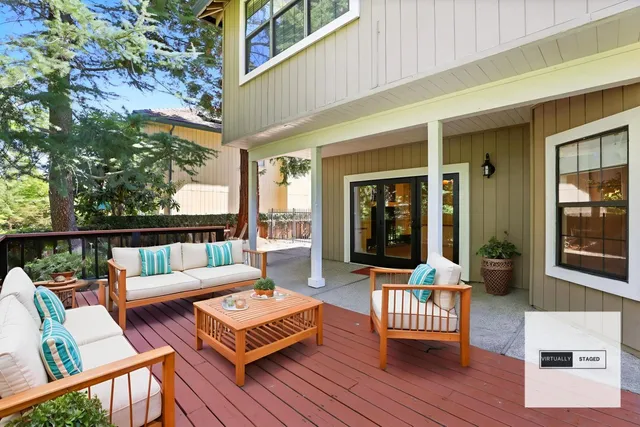 a balcony with furniture and wooden floor