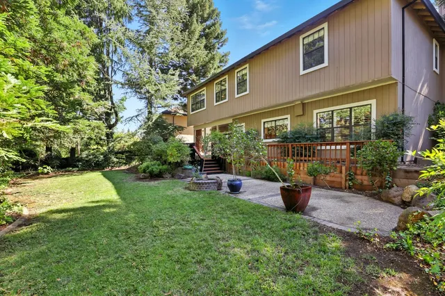 a view of a house with backyard porch and sitting area