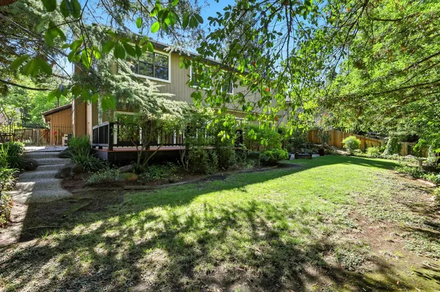 a view of backyard with swimming pool