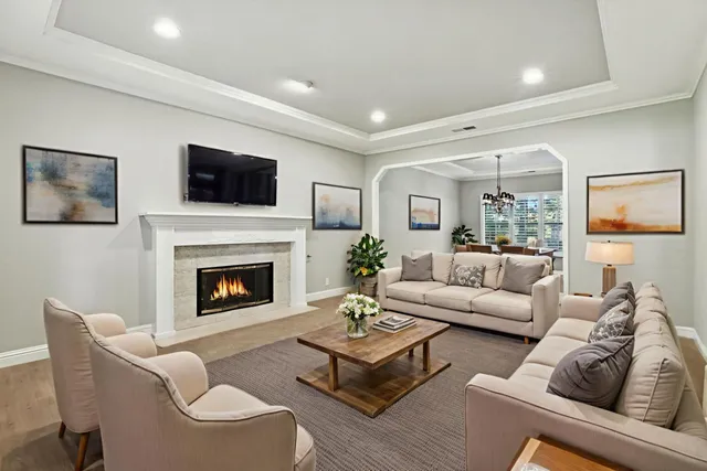 a living room with furniture a fireplace and a flat screen tv