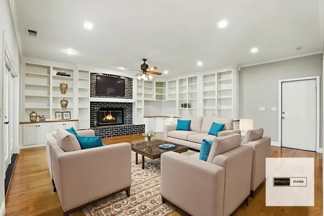 a living room with furniture fireplace and a flat screen tv