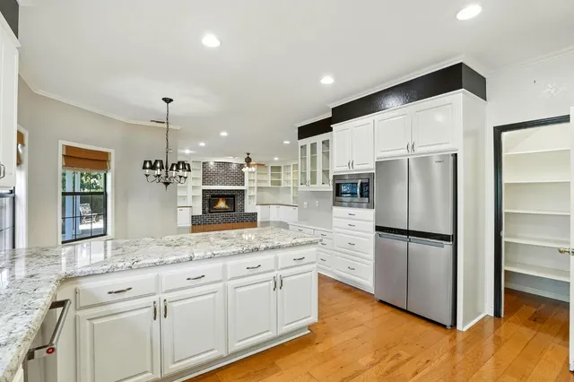 a kitchen with stainless steel appliances a refrigerator sink and microwave